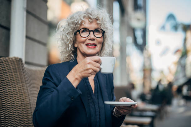 istock Beautiful senior woman drinking a hot drink 1192739112
