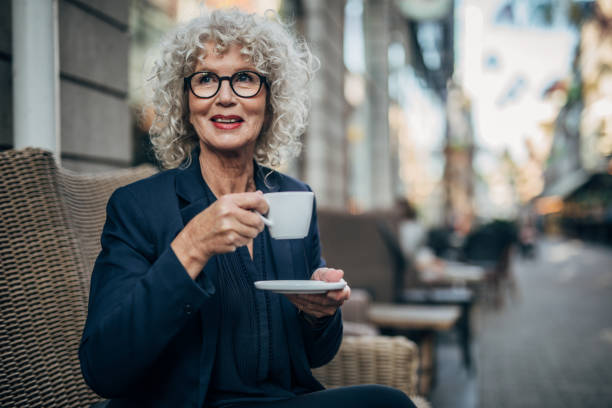 istock Beautiful senior woman drinking a hot drink 1192739146
