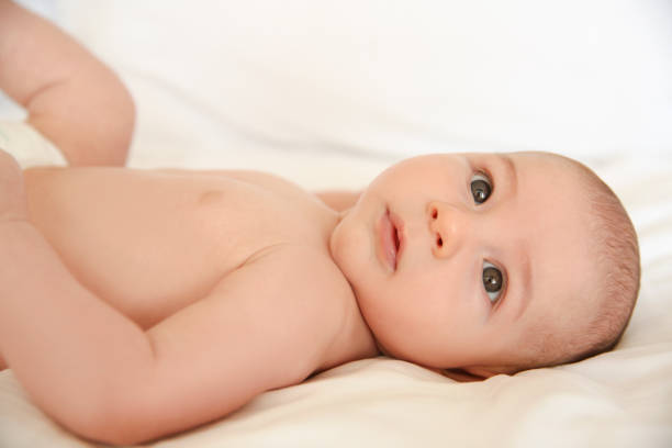 istock Cute Baby Lying On Back  Looking At The Camera 1192739404