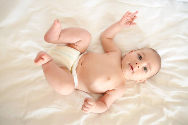 istock Cute Baby Lying On Back  Looking At The Camera 1192739449