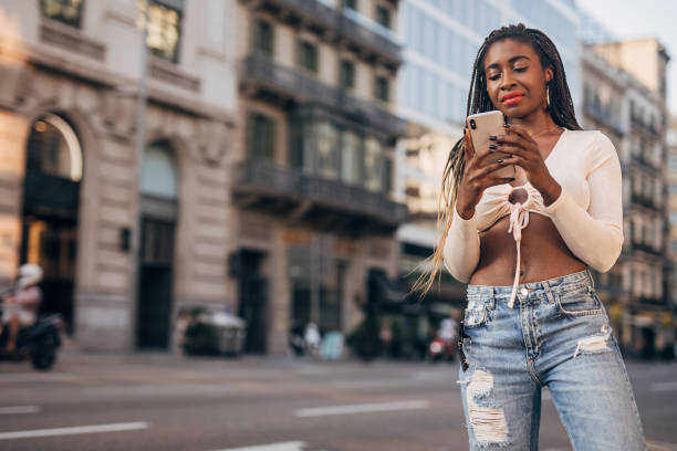 istock Woman using a phone on the street 1192741303