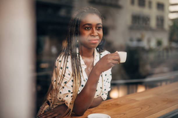 istock Young woman drinking coffee at the cafe 1192741549