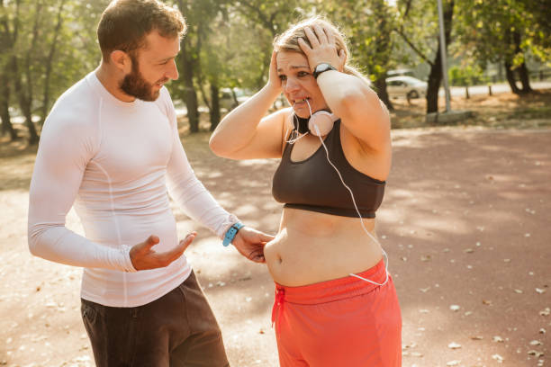 istock Overweight woman exercising. 1192742666