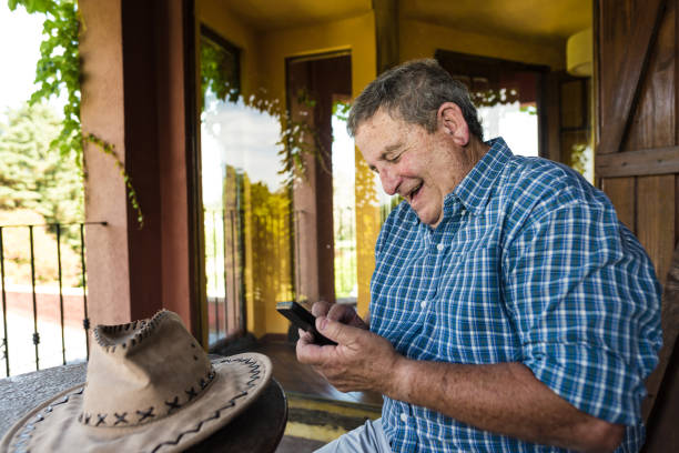 istock Senior man laughing typing messages 1192743519