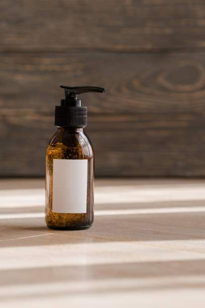 istock Cosmetic dark amber bottles on wooden  table 1192743664