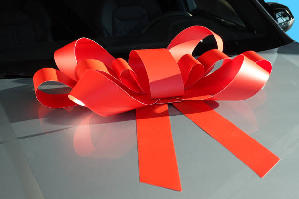 istock Red gift ribbon on a car mask 1192745732