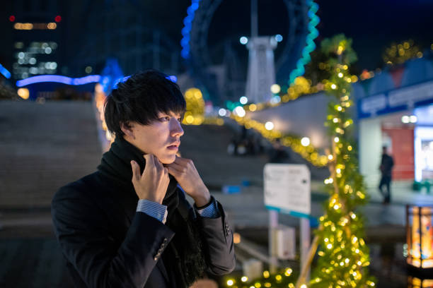 istock Young man in suit waiting for someone at Christmas night 1192752433