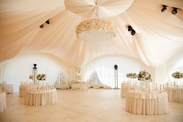 Luxurious high tent decorated for wedding celebration. Luxurious high tent decorated for wedding celebration. wedding hall stock pictures, royalty-free photos & images