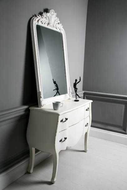 istock An expensive modern white mirror with a pedestal in a classic gray interior. 1192754046