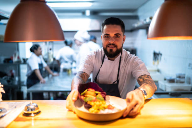 istock Portrait of chef showing his ready dish 1192754704