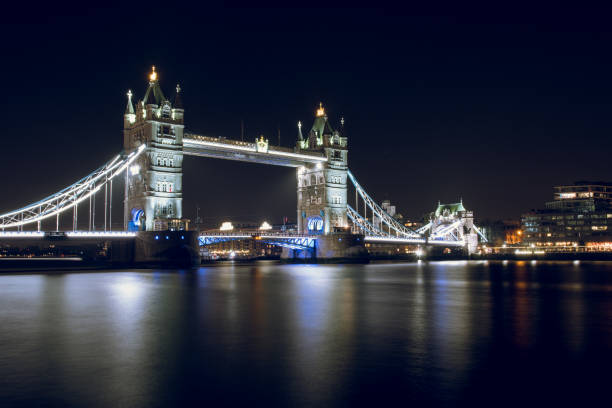 Tower Bridge Illuminated at Night in the City of London, UK.