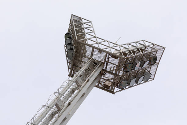 istock Diagonal ground view of mighty stadium lightning system. 1192759911