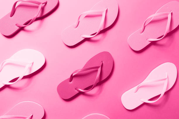 istock Multicolor flip flops on the solid background toned in trendy seasonal color, monochrome image 1192759951