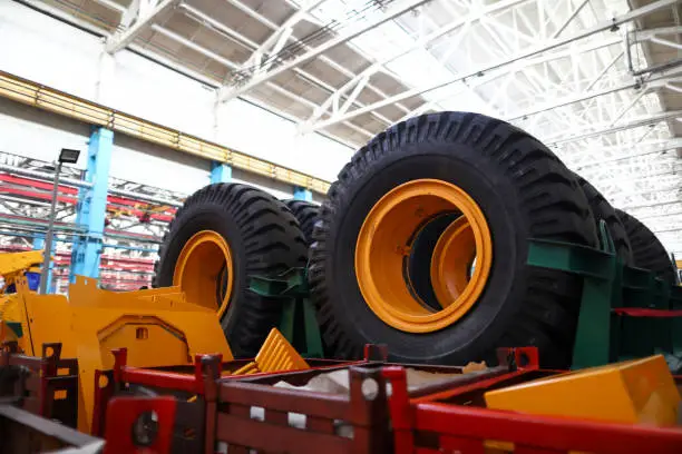 Set of extremely big wheels standing at warehouse of machine building plant