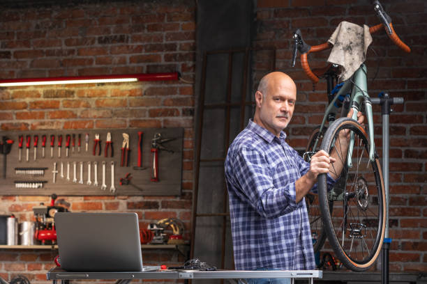 istock Mechanic or rider replacing the wheel on a bicycle 1192760147