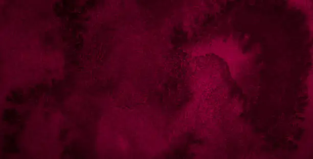 Dark saturated burgundy watercolor background with torn strokes and uneven spots. Trend color texture. Abstract background for design, layouts and patterns.