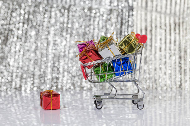 Beautiful gift boxes and shopping carts on the table In front of the shiny background lay the exquisite gift box 7944 stock pictures, royalty-free photos & images