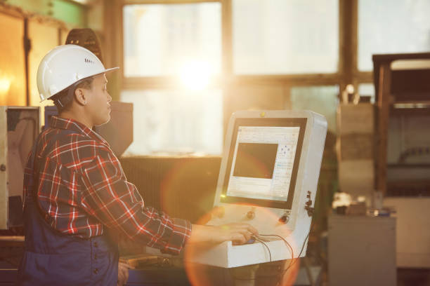 istock Female Worker Operating Machines in Sunlight 1192778679