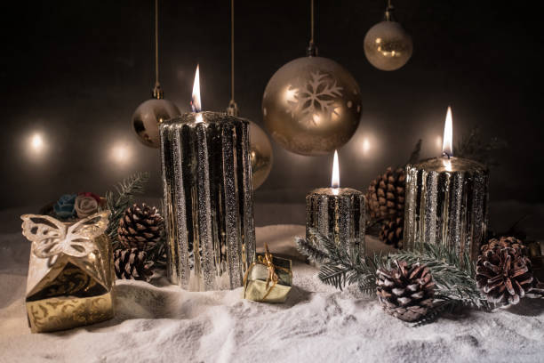 istock Creative artwork decoration. Christmas decoration with burning candles on a dark background. Christmas ornaments over dark golden background with lights. 1192779619