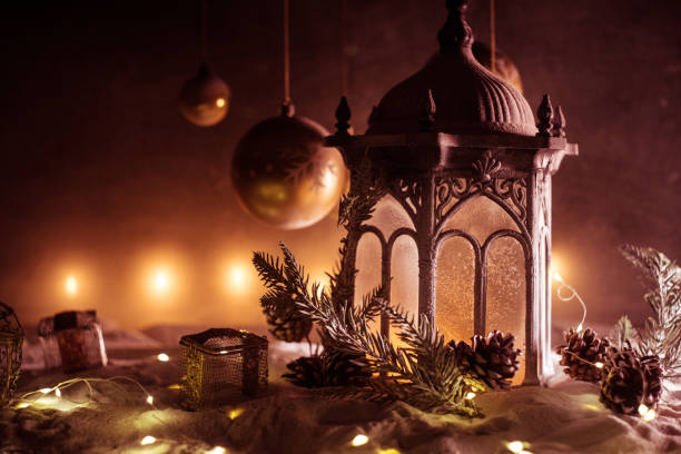 istock Creative artwork decoration. Christmas decoration with burning candles on a dark background. Christmas ornaments over dark golden background with lights. 1192779649