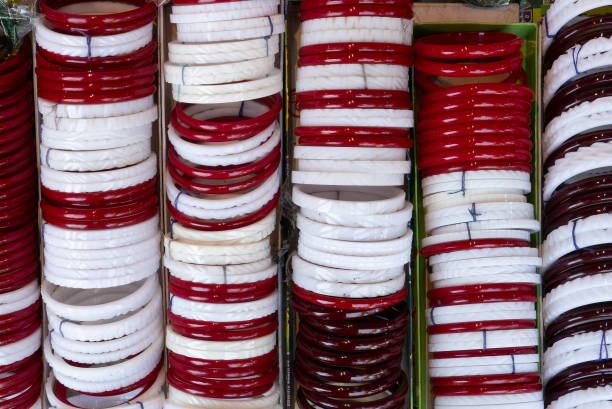 Traditional bangles Shakha and Paula, one pair of red and one pair of white Conch shell bangles, to be worn by Bengali Hindu bride while getting married. Being sold at Kalighat, Kolkata, India.