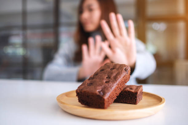 istock A woman making hand sign to refuse a brownie cake 1192779718