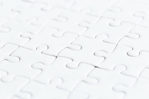 istock close up white jigsaw game puzzle. 1192782322