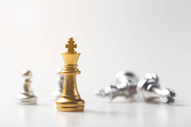 istock chess game gold king standing and silver background, business strategy concept. 1192782348