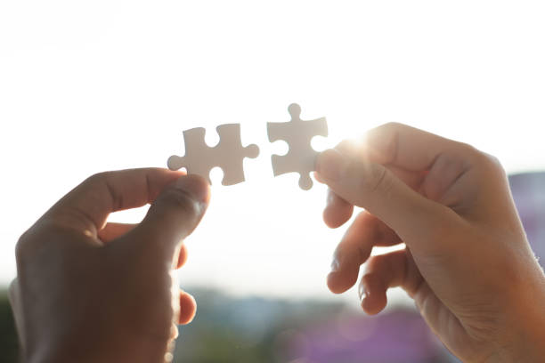 istock Connect jigsaw pieces to create network connection silhouette sunset, Business concept. 1192782349