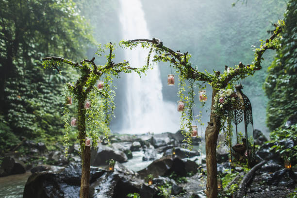 istock Unusual wedding ceremony arch with waterfall view in jungle rainforest. Dream Wedding ceremony in Bali. 1192789028
