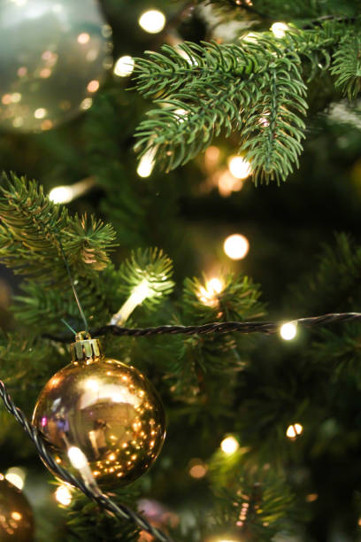 istock Christmas tree decorated with golden shiny baubles 1192794403