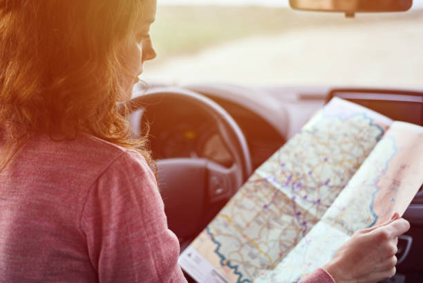 istock Woman looking at the navigation map while driving car 1192802052
