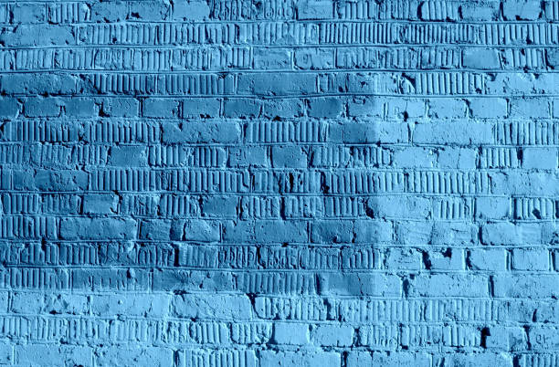 Old brick wall texture close up. Abstract background blue color toned