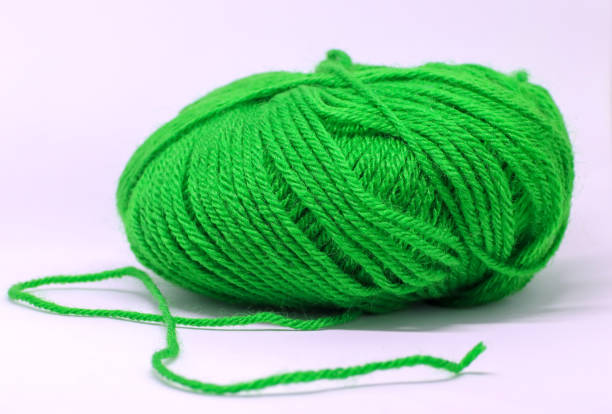 istock a ball of green wool in white background 1192806815