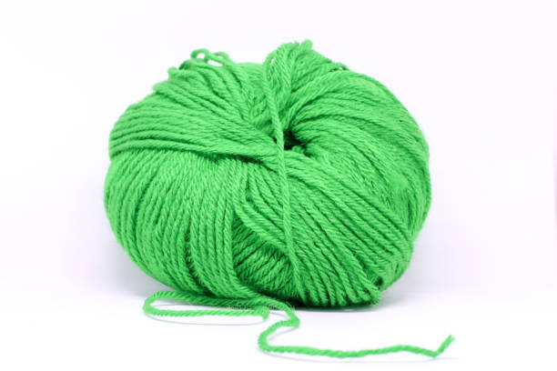 istock a ball of green wool in white background 1192806888
