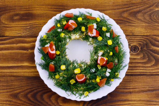 istock Salad Christmas wreath on a wooden table. Top view 1192809801