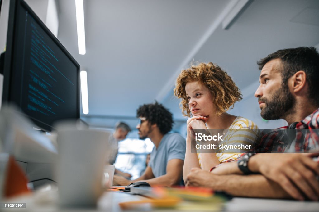 Computer Programmers Reading Codes On A Pc In The Office Stock Photo ...