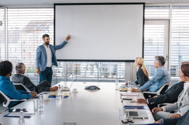 istock CEO giving a business presentation through projection screen in a board room. 1192811992