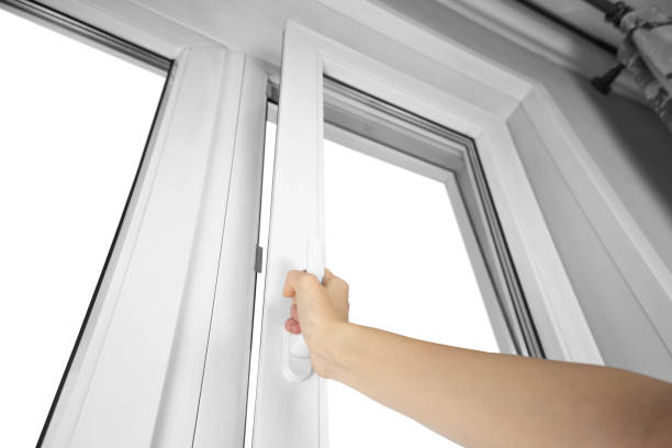 The hand opens the white plastic the window. Close up.