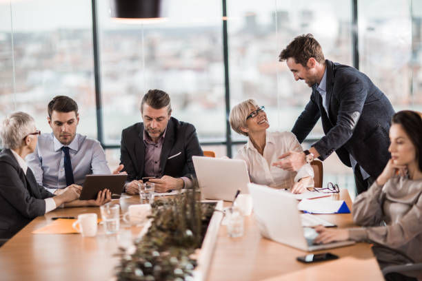 istock Business team using wireless technology in a board room. 1192815186