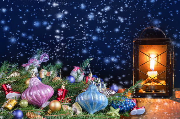 istock Beautiful Christmas card with decorated spruce branches and a lit old lantern. 1192818540