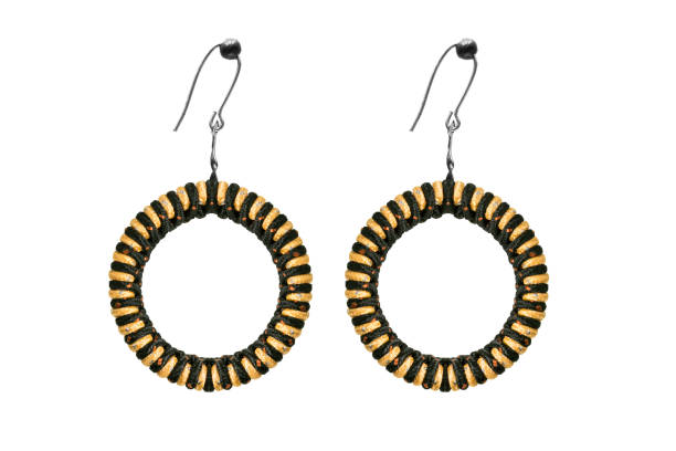 Textile earrings isolated Ethnic textile black and yellow hoop earrings on white background hoop earring stock pictures, royalty-free photos & images