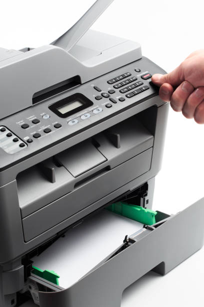 istock Hand press button on panel of printer. printer scanner laser office copy machine supplies start concept 1192819820
