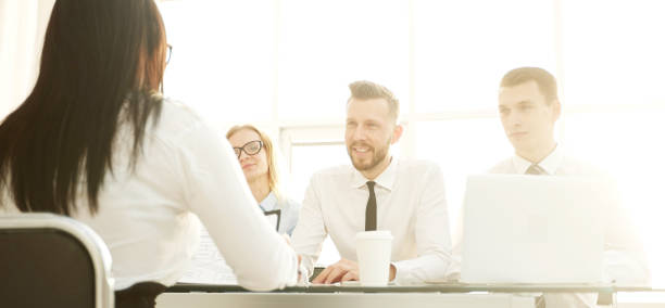 istock young female candidate answering questions during interview 1192820599