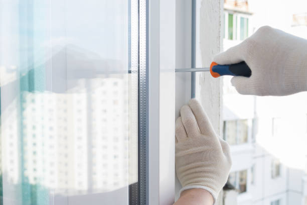 istock gloved hands adjust a new installed window with a screwdriver, closeup 1192820668