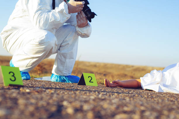 istock Detective studying a crime scene taking photographs. 1192821158