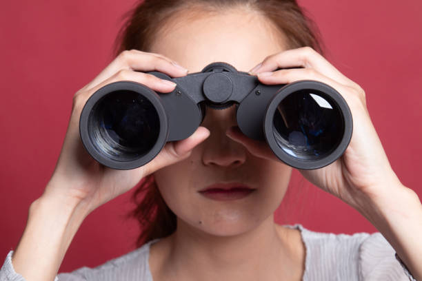 istock Young Asian woman with binoculars. 1192821263