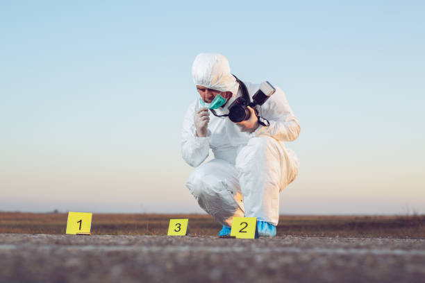 istock Detective studying a crime scene taking photographs. 1192821285