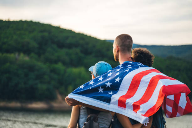 istock Group of hikers waving with American flag 1192821898