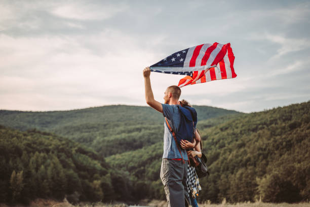 istock Group of hikers waving with American flag 1192821920